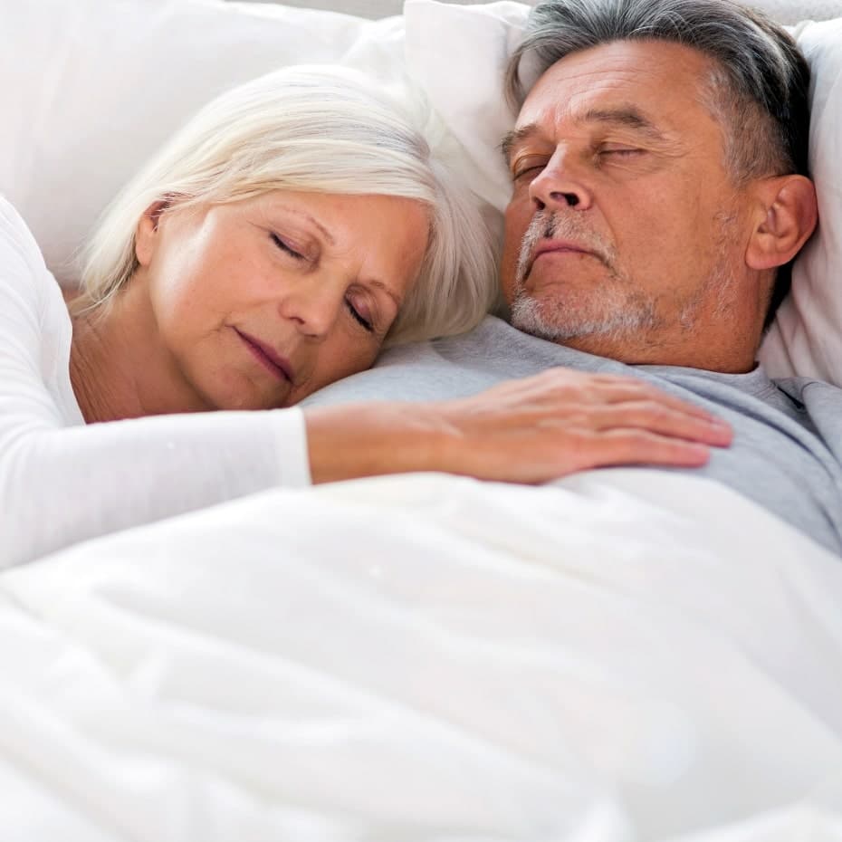 senior couple sleeping peacefully thanks to no more snoring